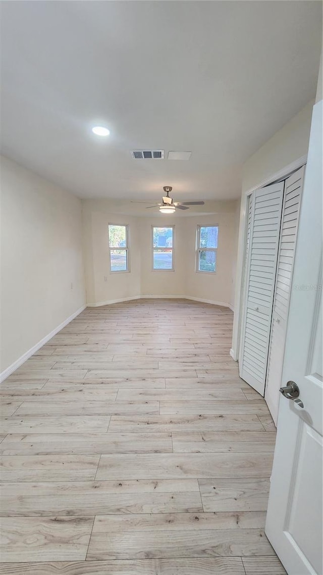 unfurnished room featuring ceiling fan and light wood-type flooring