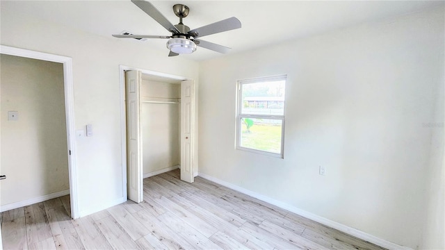 unfurnished bedroom featuring light hardwood / wood-style floors, a closet, and ceiling fan