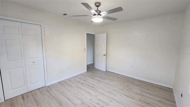 unfurnished bedroom featuring a closet, ceiling fan, and light wood-type flooring