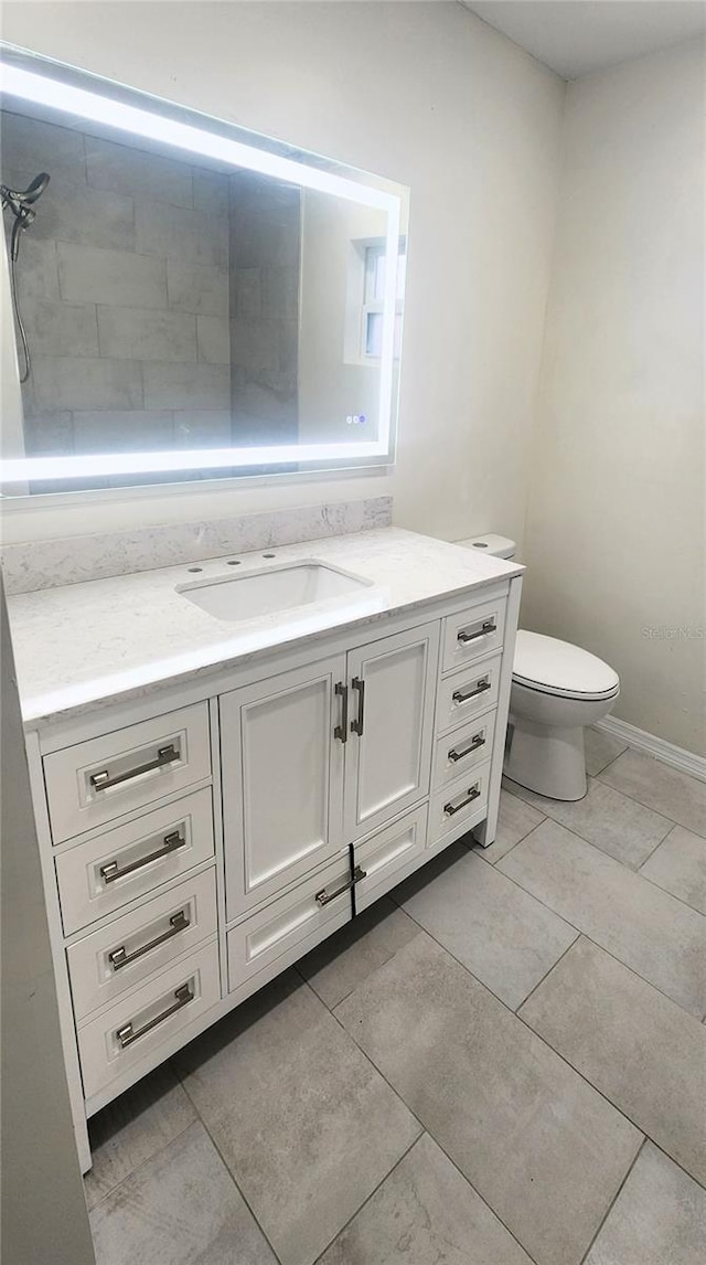 bathroom featuring vanity, toilet, and tile patterned flooring