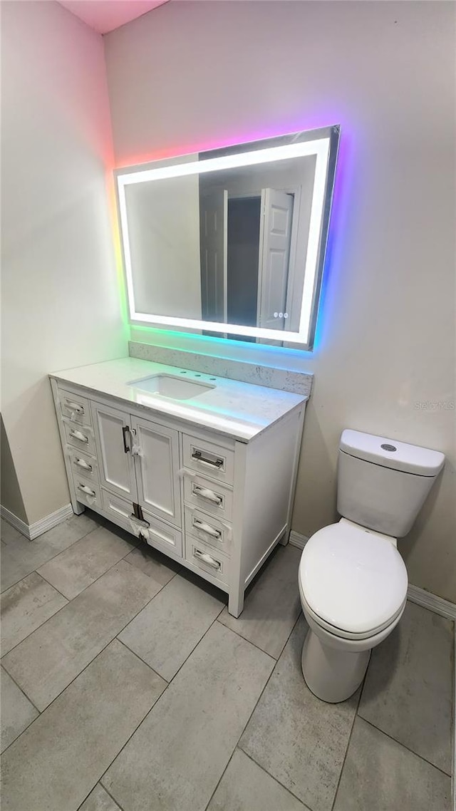 bathroom with vanity, tile patterned floors, and toilet