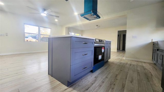 kitchen featuring stainless steel electric range oven, light hardwood / wood-style flooring, ceiling fan, and island exhaust hood