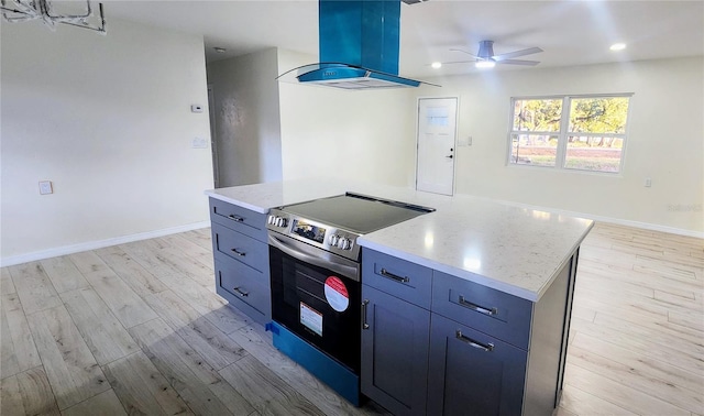 kitchen featuring a kitchen island, island range hood, electric range, light stone countertops, and light wood-type flooring