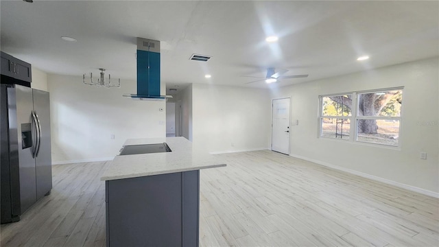 kitchen featuring light stone counters, stainless steel fridge with ice dispenser, light hardwood / wood-style floors, and island exhaust hood