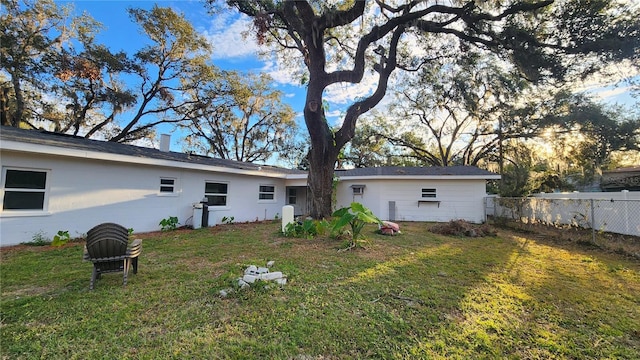 back of property featuring a lawn