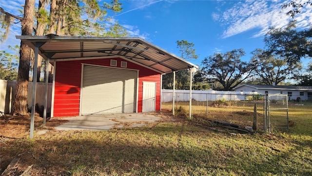 exterior space with a carport and a lawn