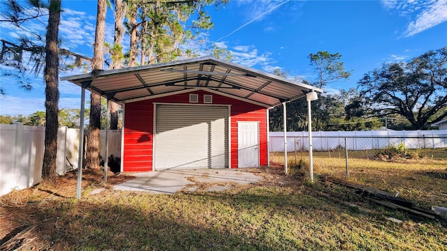 garage with a carport and a lawn