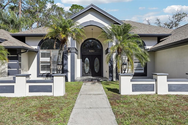 doorway to property featuring a lawn