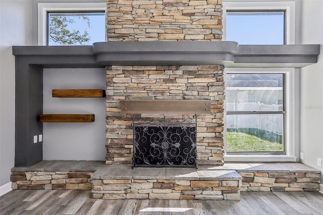 interior details featuring a fireplace and hardwood / wood-style floors