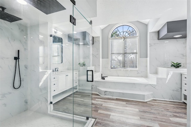 bathroom with lofted ceiling, vanity, plus walk in shower, and hardwood / wood-style floors