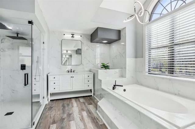 bathroom featuring vanity, independent shower and bath, hardwood / wood-style floors, and tile walls