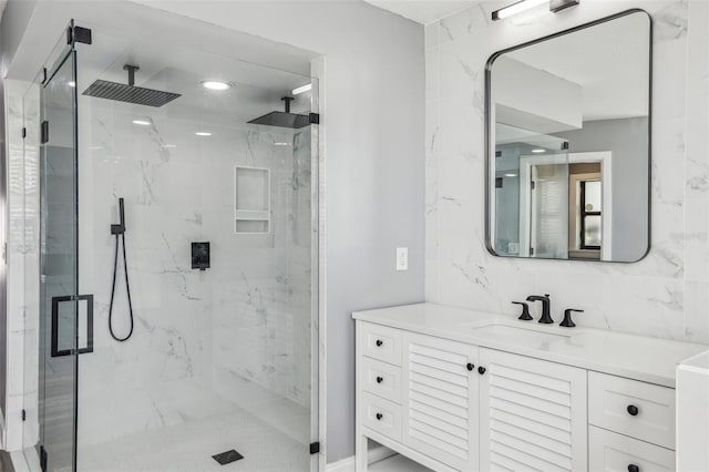 bathroom featuring vanity, an enclosed shower, and backsplash