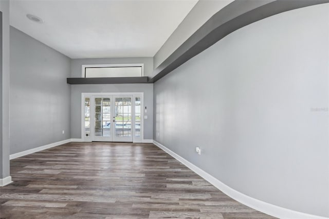 spare room with hardwood / wood-style flooring and french doors