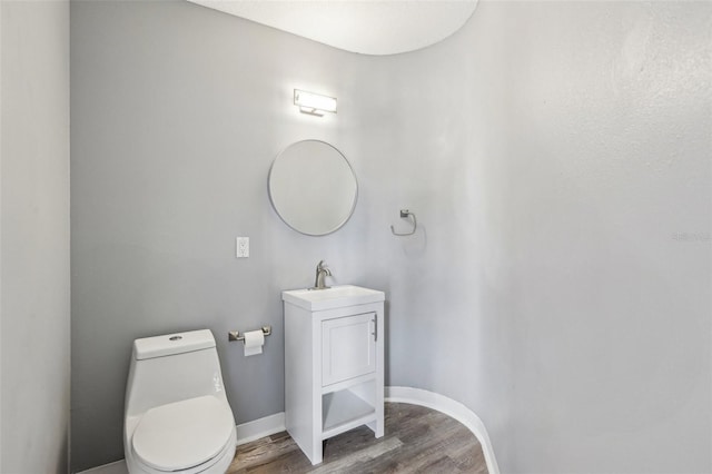 bathroom with vanity, hardwood / wood-style floors, and toilet