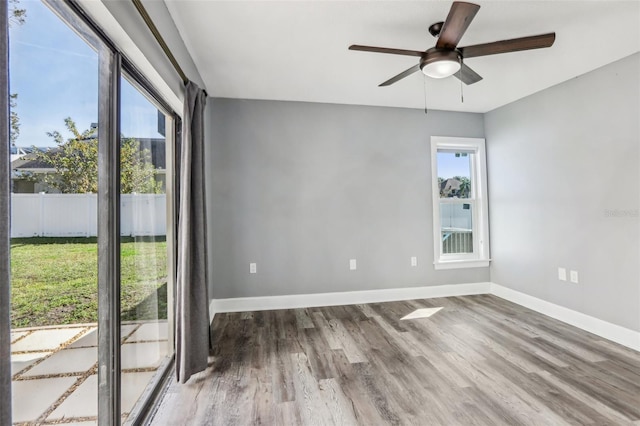 spare room with hardwood / wood-style flooring and ceiling fan