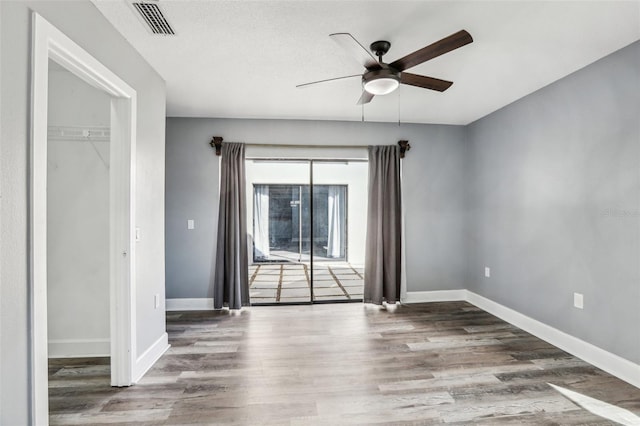 interior space with hardwood / wood-style flooring and ceiling fan