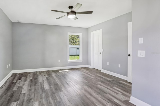 spare room featuring ceiling fan and dark hardwood / wood-style floors