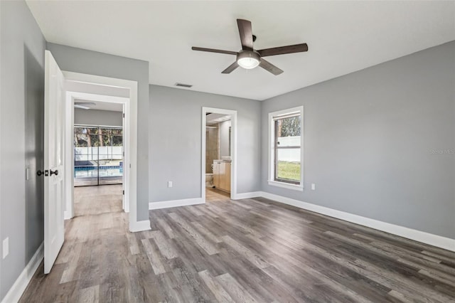 unfurnished bedroom featuring ceiling fan, connected bathroom, and light wood-type flooring