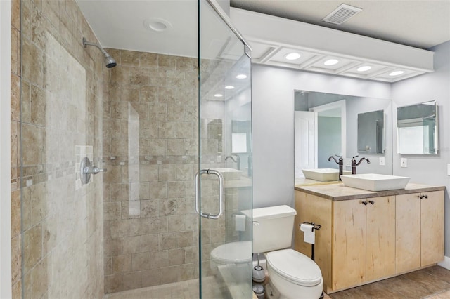 bathroom with an enclosed shower, vanity, tile patterned floors, and toilet