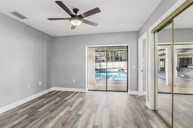 unfurnished room featuring hardwood / wood-style flooring and ceiling fan