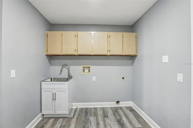 washroom featuring sink, cabinets, hookup for a washing machine, electric dryer hookup, and hardwood / wood-style flooring