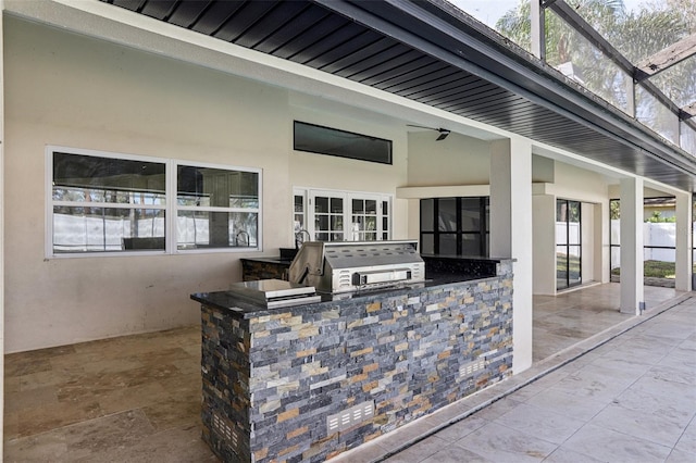 view of patio / terrace with a bar, area for grilling, and a lanai