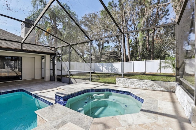 view of swimming pool with a patio area, glass enclosure, and an in ground hot tub