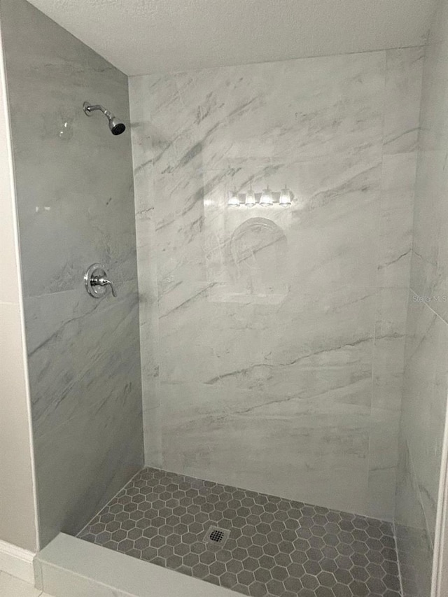 bathroom with a tile shower