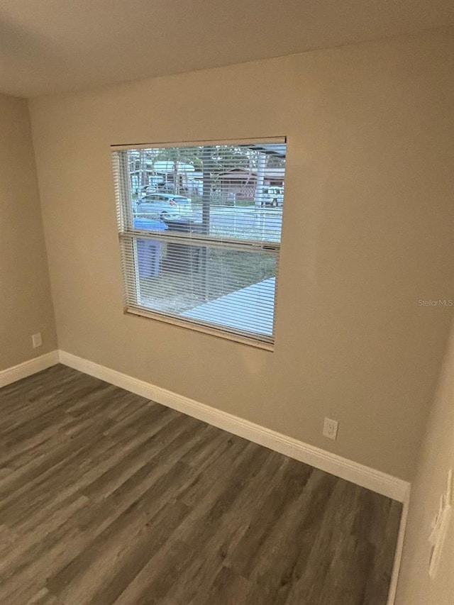 unfurnished room featuring dark hardwood / wood-style flooring