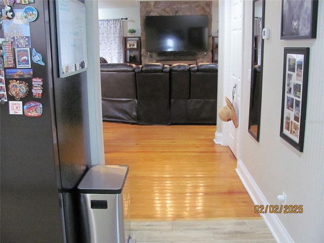 hallway with hardwood / wood-style floors