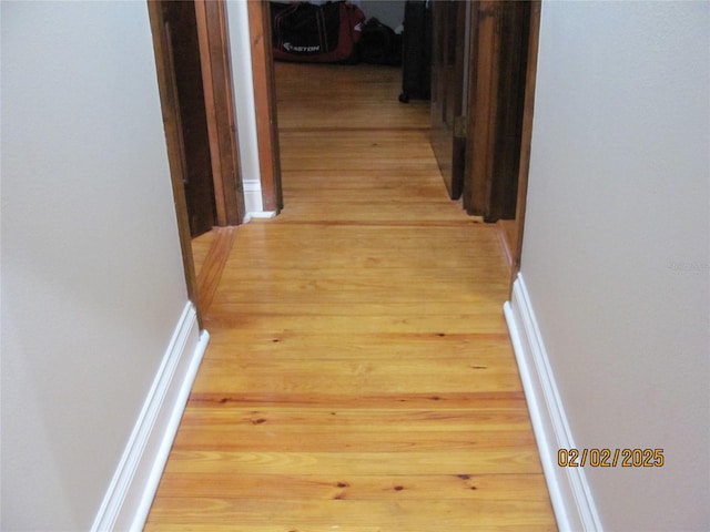 corridor with light hardwood / wood-style floors