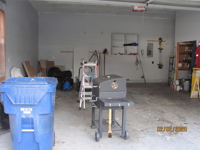 garage with a garage door opener and electric panel