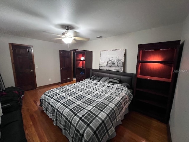 bedroom with dark wood-type flooring and ceiling fan