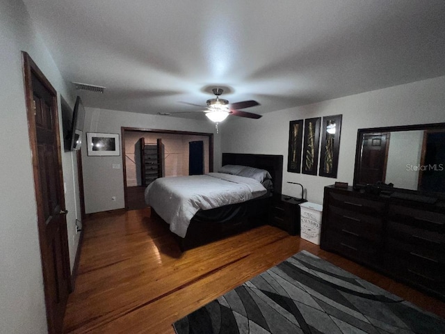 bedroom with dark wood-type flooring and ceiling fan