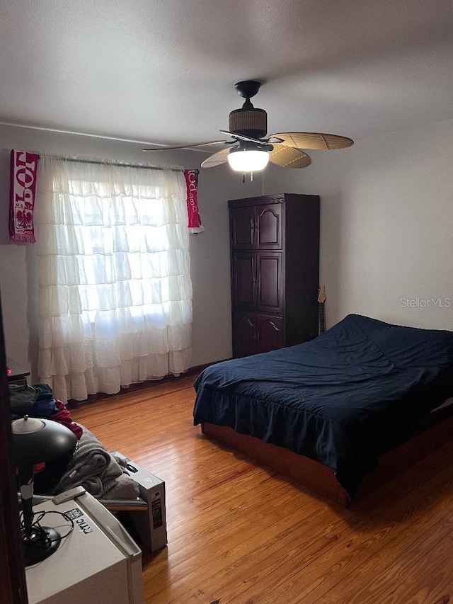 bedroom featuring ceiling fan and light hardwood / wood-style floors