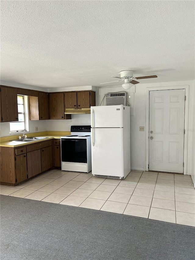 kitchen featuring white appliances, light tile patterned floors, a ceiling fan, light countertops, and under cabinet range hood