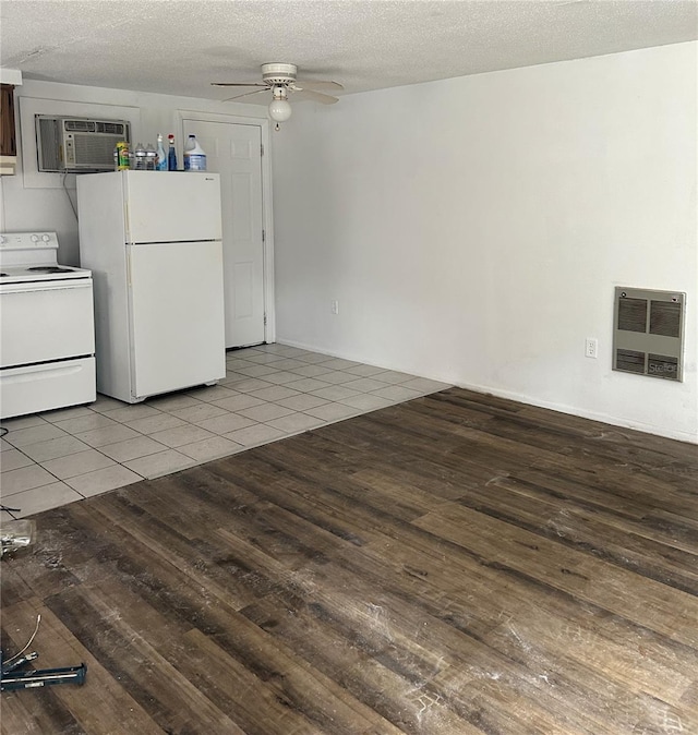 kitchen featuring white appliances, light tile patterned floors, ceiling fan, a wall mounted air conditioner, and heating unit