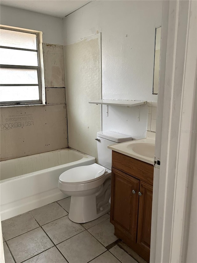 bathroom featuring a tub to relax in, vanity, toilet, and tile patterned floors