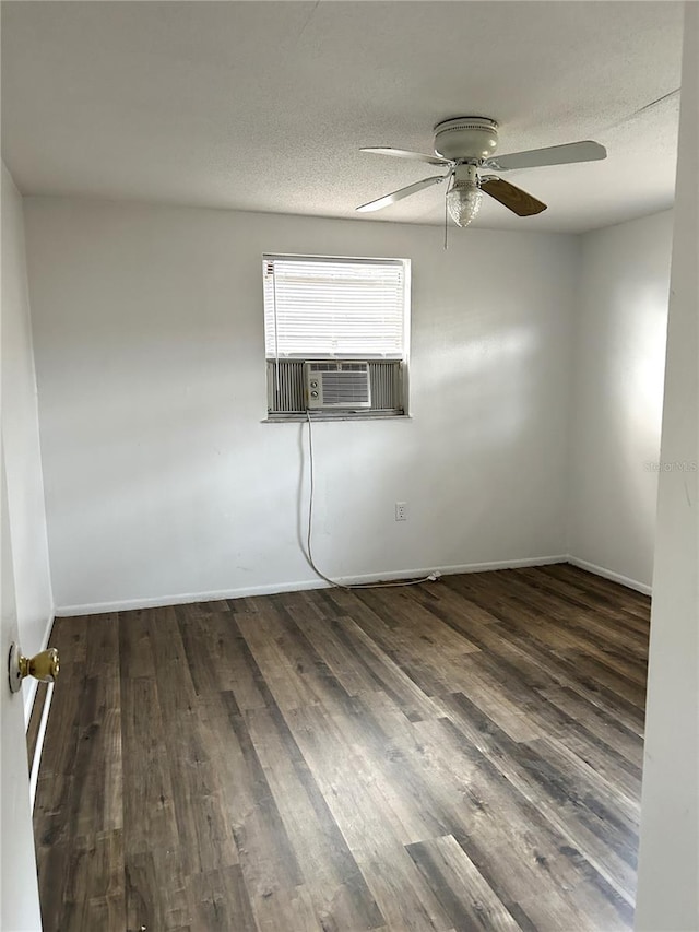 unfurnished room featuring a textured ceiling, cooling unit, and wood finished floors