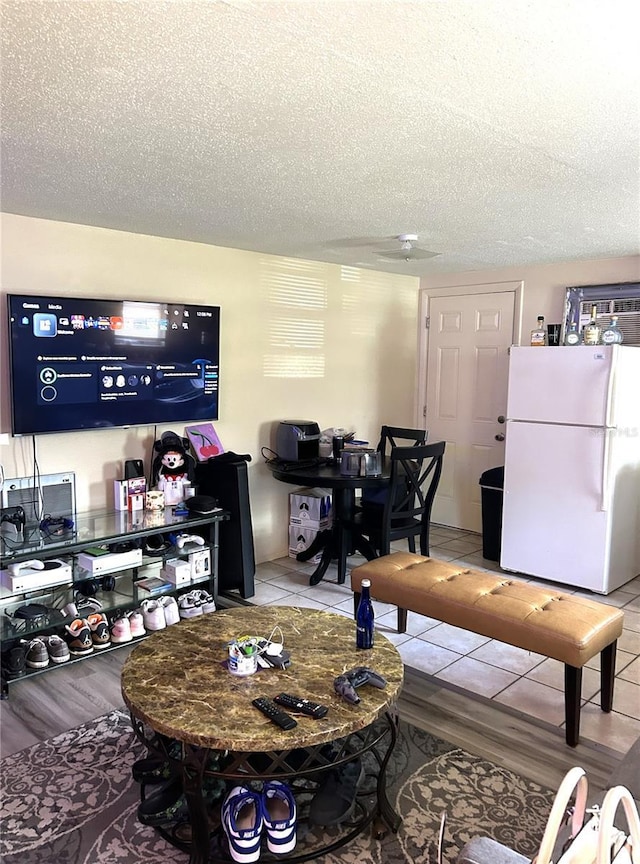 tiled living area with a textured ceiling