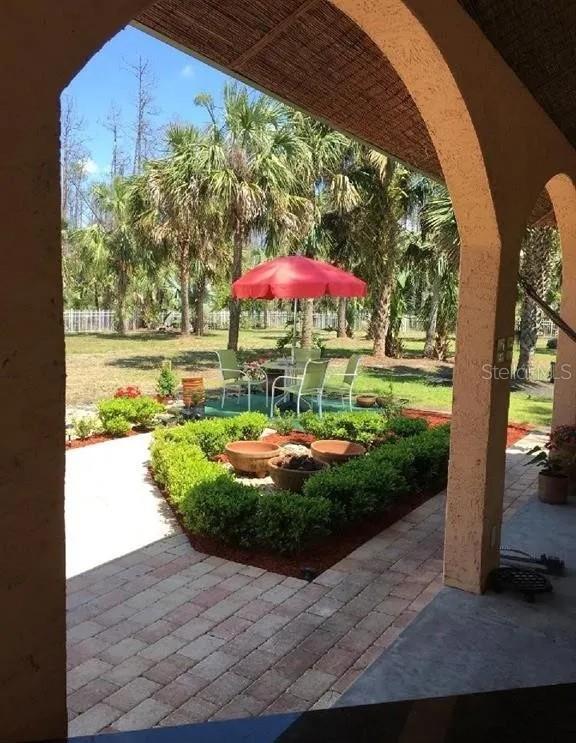 view of property's community with a patio and a yard