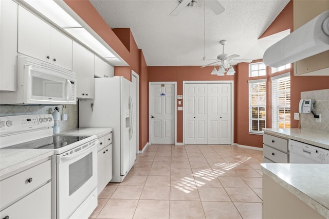 kitchen featuring ceiling fan, light tile patterned floors, white cabinets, and white appliances