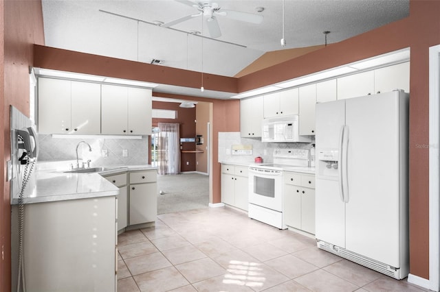 kitchen featuring sink, white appliances, white cabinetry, backsplash, and vaulted ceiling