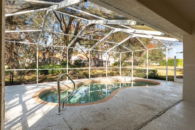 view of pool featuring a patio area and glass enclosure