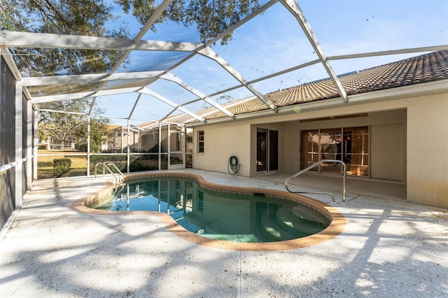 view of pool with a patio and glass enclosure