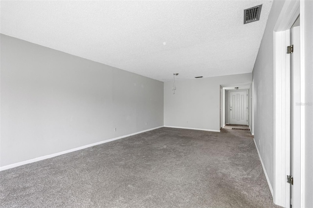 unfurnished room featuring carpet and a textured ceiling