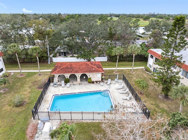 view of swimming pool featuring a patio and a lawn