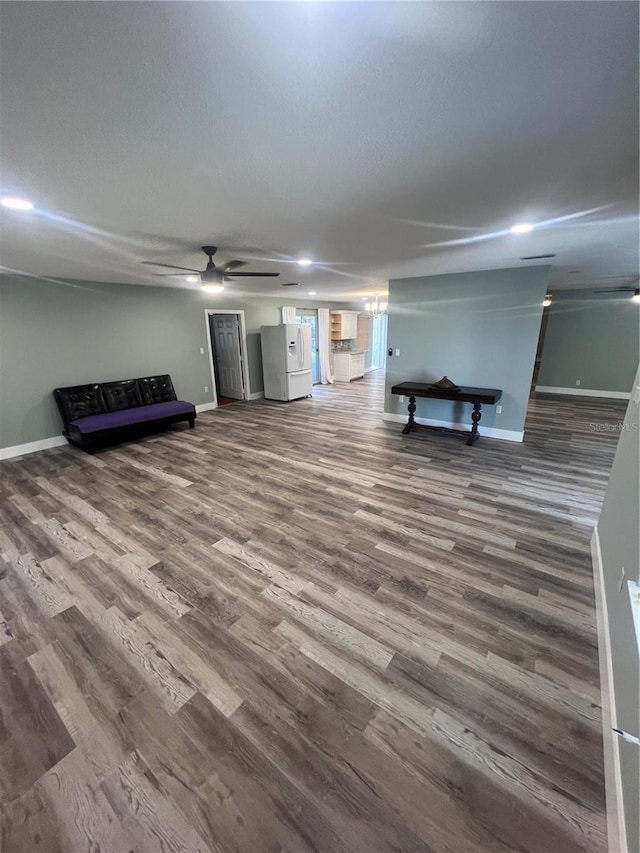 unfurnished living room featuring hardwood / wood-style floors, a textured ceiling, and ceiling fan