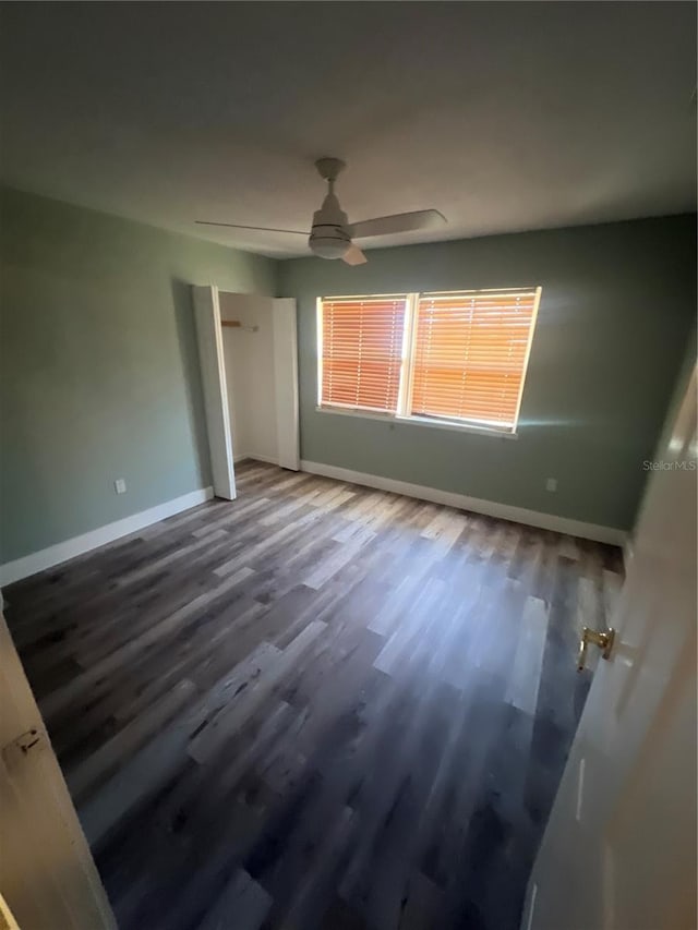 unfurnished bedroom with ceiling fan, hardwood / wood-style floors, and a closet