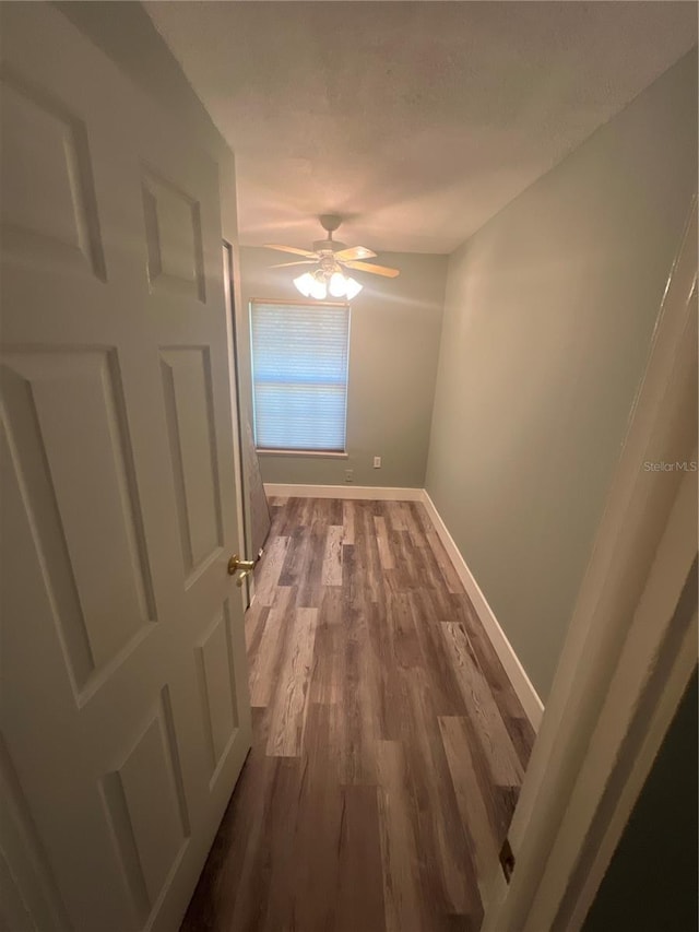 hallway featuring hardwood / wood-style flooring and a textured ceiling